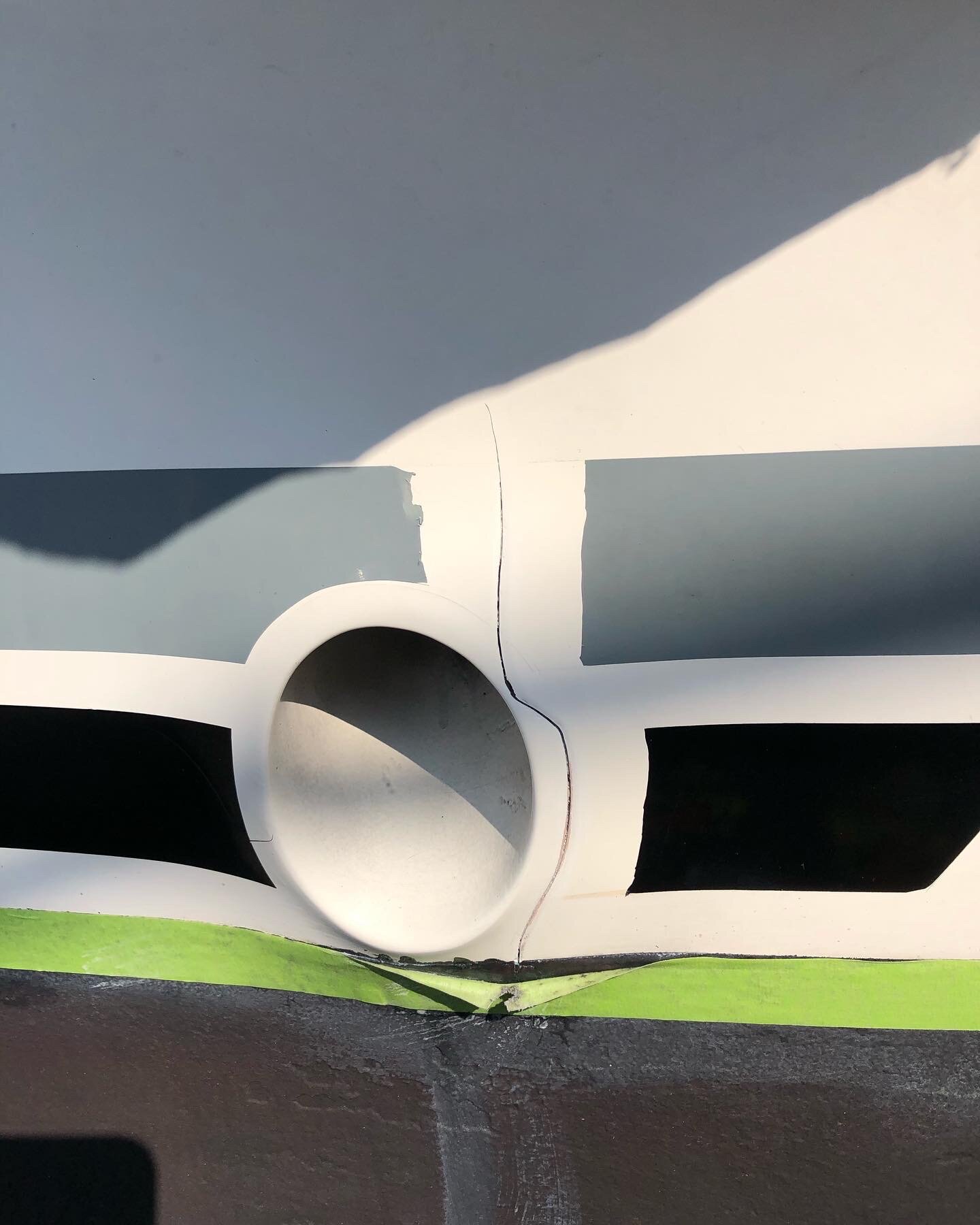 Cracked gelcoat around a hull fitting before repair